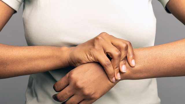 A woman massaging her painful wrists