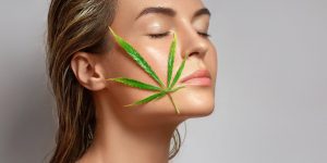A woman with a hemp leaf resting on her face