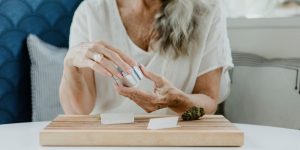 Woman using metal weed grinder