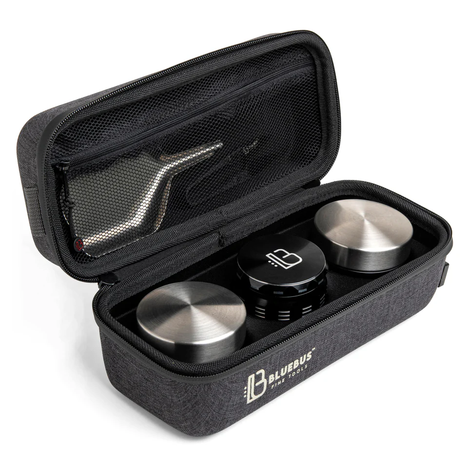 Open BlueBus Bulldog smell-proof case showing stainless steel containers, black grinder, and mesh pocket with metal tool inside.